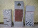 Elemental sculpture with the pieces each representing water, sun and earth