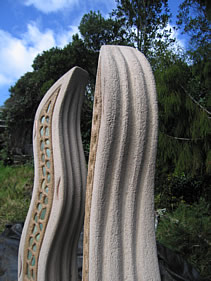 A river reaching towards the sky represented by elemental inlays, shadow lines on three sides and also negative airspace between the pair. Inset curved copper denotes the headlands that shape the rivers path